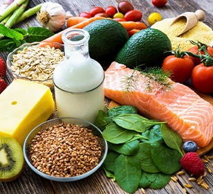 Various healthy foods piled together on a wooden surface