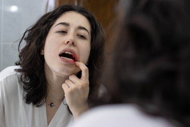 Patient holding her mouth due to inflamed gums