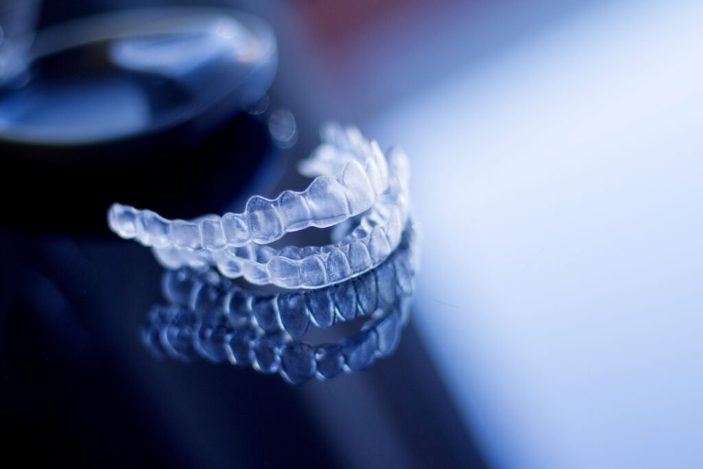 Clear aligners on a reflective dark surface